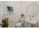 Modern half bathroom featuring contemporary fixtures, natural light, and stylish décor at 25 Carlton Ln, Franklinton, NC 27525