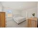 Bright bedroom with neutral walls, plush carpet, and a large window overlooking the backyard at 25 Carlton Ln, Franklinton, NC 27525