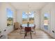 Dining area featuring a modern chandelier and natural light, adjacent to a door to the backyard at 25 Carlton Ln, Franklinton, NC 27525