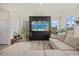 Sun-lit living room with hardwood floors, neutral walls, and large windows with an outside view at 25 Carlton Ln, Franklinton, NC 27525