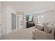 Spacious living room featuring plush seating, a large screen TV, neutral carpeting, and ample natural light at 25 Carlton Ln, Franklinton, NC 27525