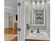 A bathroom featuring a sink with a quartz countertop, a mirror, and sconce lighting at 250 Spring View Ln, Pittsboro, NC 27312