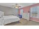 Charming bedroom featuring twin beds, two windows and a modern ceiling fan at 250 Spring View Ln, Pittsboro, NC 27312