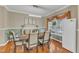 Dining room with a long table, seating for six, wood floors, and a window with natural light at 250 Spring View Ln, Pittsboro, NC 27312
