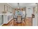 A dining room with a long table, seating for six, a white sideboard, and wood floors at 250 Spring View Ln, Pittsboro, NC 27312