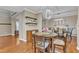 A dining room with a round glass table, seating for four, and hardwood floors at 250 Spring View Ln, Pittsboro, NC 27312