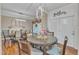 A dining room with a round glass table, wood chairs, modern lighting, and light-colored walls at 250 Spring View Ln, Pittsboro, NC 27312