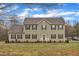 Charming two-story home features a well-manicured lawn and classic architecture under a bright, partly cloudy sky at 250 Spring View Ln, Pittsboro, NC 27312