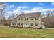 Charming two-story home features a well-manicured lawn and classic architecture under a bright, partly cloudy sky at 250 Spring View Ln, Pittsboro, NC 27312