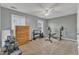 Brightly lit gym with neutral paint, a ceiling fan, and weightlifting equipment and a rowing machine at 250 Spring View Ln, Pittsboro, NC 27312