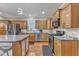 A modern kitchen with wood cabinets, stainless steel appliances, and a tile backsplash at 250 Spring View Ln, Pittsboro, NC 27312