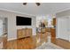 Open-concept living area with wood floors, tv, and eat-in kitchen at 250 Spring View Ln, Pittsboro, NC 27312