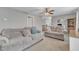 Open-concept living area with plush sofas, a ceiling fan, and neutral decor at 250 Spring View Ln, Pittsboro, NC 27312