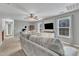 Bright living area with sofa, wall-mounted tv and neutral paint at 250 Spring View Ln, Pittsboro, NC 27312