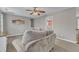 Large neutral living room with sofas, a ceiling fan, and staircase access to the floor below at 250 Spring View Ln, Pittsboro, NC 27312