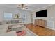 Comfortable living room featuring modern decor, shiplap wall, and plush sectional at 250 Spring View Ln, Pittsboro, NC 27312