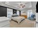 Bright main bedroom with a trey ceiling, dark accent wall, and neutral-toned furniture at 250 Spring View Ln, Pittsboro, NC 27312