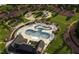 Aerial view of a community pool, playground, and walking paths nestled in a lush green landscape at 3015 Dog Rose Drive Lot 170 Dr, Durham, NC 27703