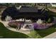 A stunning exterior view of a modern clubhouse, landscaped with purple flowers and walking paths at 3015 Dog Rose Drive Lot 170 Dr, Durham, NC 27703