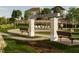 Outdoor fire pit area with stone pillars, benches, string lights, and a gathering space for residents at 3015 Dog Rose Drive Lot 170 Dr, Durham, NC 27703