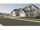 Street view showcasing well-maintained homes with garages, landscaping, and sidewalks at 3015 Dog Rose Drive Lot 170 Dr, Durham, NC 27703