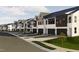 Modern townhomes lined up on a street with well-kept lawns and convenient parking spaces at 3015 Dog Rose Drive Lot 170 Dr, Durham, NC 27703