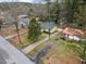 An aerial view showcases the home's location amidst a neighborhood with mature trees and convenient street access at 304 22Nd St, Butner, NC 27509