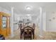 Open dining area with elegant dark wood table, chairs, and white columns adjacent to the kitchen at 304 22Nd St, Butner, NC 27509