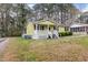 Quaint single-story home with a welcoming front porch and a lush lawn at 304 22Nd St, Butner, NC 27509