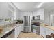 Bright kitchen featuring stainless steel appliances, granite countertops and ample cabinet space at 304 22Nd St, Butner, NC 27509