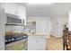 Functional kitchen area equipped with modern appliances and convenient laundry access at 304 22Nd St, Butner, NC 27509