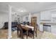 Inviting living room and dining area featuring tile floors, white columns, and comfortable seating at 304 22Nd St, Butner, NC 27509