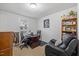 Comfortable home office with desk, bookshelves, and a cozy recliner at 304 22Nd St, Butner, NC 27509