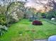 Spacious backyard featuring lush lawn, mature trees, and a relaxing atmosphere at 309 College St, Oxford, NC 27565