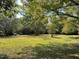 Expansive backyard with mature trees, offering a private and serene outdoor space at 309 College St, Oxford, NC 27565