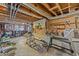 Unfinished basement with exposed beams, concrete floor, and work area at 309 College St, Oxford, NC 27565