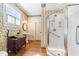 Charming bathroom with vintage wallpaper, walk-in shower and pedestal sink at 309 College St, Oxford, NC 27565