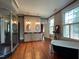 Bathroom with a clawfoot tub, a glass enclosed shower and hardwood floors at 309 College St, Oxford, NC 27565