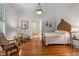 Serene bedroom with hardwood floors, classic decor, and warm lighting at 309 College St, Oxford, NC 27565