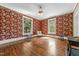 Bright bedroom featuring large windows, floral wallpaper, and vintage decor at 309 College St, Oxford, NC 27565