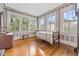 Traditional bedroom with hardwood floors, period wallpaper and abundant natural light at 309 College St, Oxford, NC 27565