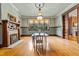 Elegant dining room with period chandelier and hardwood floors at 309 College St, Oxford, NC 27565