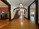 Grand foyer featuring hardwood floors, staircase, and view of interior rooms at 309 College St, Oxford, NC 27565
