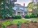 Beautiful front exterior featuring a welcoming porch and well-kept landscaping, showcasing classic design at 309 College St, Oxford, NC 27565
