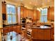 Open kitchen with island, custom cabinets, and adjacent dining area at 309 College St, Oxford, NC 27565