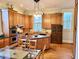 Kitchen with custom cabinets, center island, stainless steel appliances, and dining area at 309 College St, Oxford, NC 27565