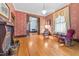 Charming living room featuring vintage decor, fireplace, and decorative lighting at 309 College St, Oxford, NC 27565