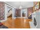 Elegant living room boasting detailed wallpaper, fireplace, and hardwood flooring at 309 College St, Oxford, NC 27565
