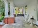 Side porch view with white Adirondack chairs and painted brick pillars at 309 College St, Oxford, NC 27565