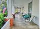 Wide, side porch with furniture and white posts with painted red brick bases at 309 College St, Oxford, NC 27565